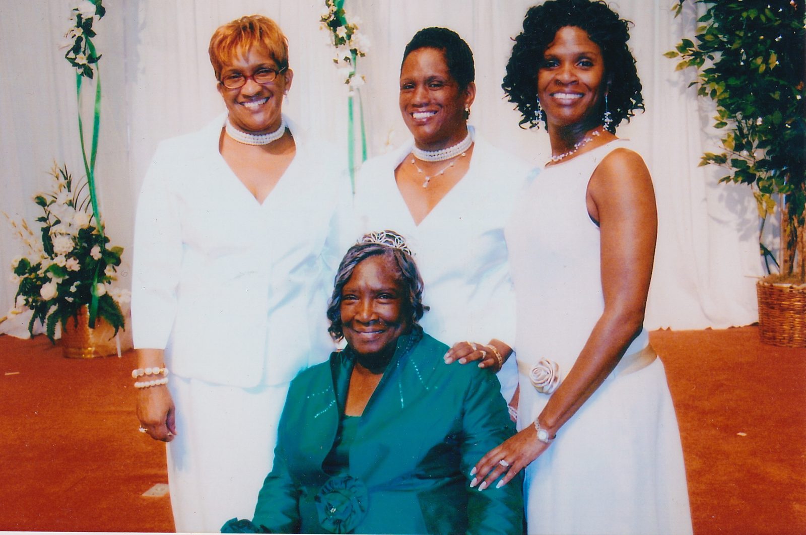 Annie Will Bell Gatlin, seated in green, with her three daughters standing behind her in white